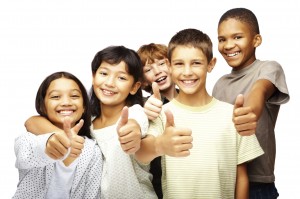 Happy children with thumbs up over white background
